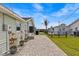 A backyard with a brick paver patio, colorful potted plants, and a view of the water at 3328 Gulfview Dr, Hernando Beach, FL 34607