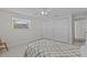 Bedroom with a large window, wood look floors, ceiling fan, and two closets at 3328 Gulfview Dr, Hernando Beach, FL 34607