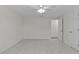 Large bedroom with white walls, ceiling fan, light wood floors, and standard door frames at 3328 Gulfview Dr, Hernando Beach, FL 34607