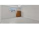 Bright bedroom featuring wood look floors, neutral walls, and a view of the property exterior at 3328 Gulfview Dr, Hernando Beach, FL 34607
