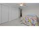 Bedroom with two closets, light wood floors, ceiling fan, and access to the adjoining room at 3328 Gulfview Dr, Hernando Beach, FL 34607