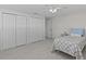 Bedroom with two closets, light wood floors, ceiling fan, and access to the adjoining room at 3328 Gulfview Dr, Hernando Beach, FL 34607