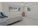 Bedroom with two windows providing natural light, a ceiling fan, and wood look flooring at 3328 Gulfview Dr, Hernando Beach, FL 34607