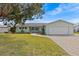 Charming single-story home with a well-manicured lawn, a paver driveway, and an attached two-car garage at 3328 Gulfview Dr, Hernando Beach, FL 34607