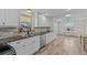 Bright kitchen featuring white cabinets, stainless steel appliances, and granite countertops at 3328 Gulfview Dr, Hernando Beach, FL 34607