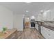 Eat-in kitchen featuring stainless appliances, white cabinets, and tile floors at 3328 Gulfview Dr, Hernando Beach, FL 34607