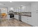 Bright kitchen features white cabinets, stainless steel appliances, granite countertops, and modern backsplash at 3328 Gulfview Dr, Hernando Beach, FL 34607