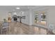 Open kitchen and dining area with updated appliances, countertops, and French doors to outdoor patio at 3328 Gulfview Dr, Hernando Beach, FL 34607