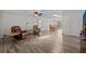Open-concept living room with wood-look tile flooring, ceiling fan and neutral decor at 3328 Gulfview Dr, Hernando Beach, FL 34607