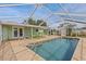 Screened in pool with outdoor seating overlooking the water, perfect for outdoor living at 3328 Gulfview Dr, Hernando Beach, FL 34607