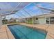Relaxing screened-in pool area with a clear view of the waterfront at 3328 Gulfview Dr, Hernando Beach, FL 34607