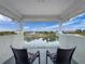 Balcony with seating overlooking a serene water view and neighboring homes at 3344 Gardenia Dr, Hernando Beach, FL 34607