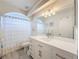 Elegant bathroom with a vanity, large mirror, decorative lighting, and a shower with white curtains at 3344 Gardenia Dr, Hernando Beach, FL 34607