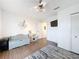 Neutral bedroom featuring wood flooring, a ceiling fan, a mini-fridge and toy kitchen set at 3344 Gardenia Dr, Hernando Beach, FL 34607