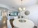 Bright dining area features a modern light fixture and an archway to an adjacent living room at 3344 Gardenia Dr, Hernando Beach, FL 34607