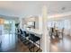 Open concept dining area features sleek bar seating and access to a covered, screened lanai at 3344 Gardenia Dr, Hernando Beach, FL 34607
