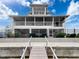 Stunning multi-level home with screened porches, complemented by a private dock at 3344 Gardenia Dr, Hernando Beach, FL 34607