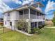 Charming multi-story house featuring large screened porches and well-maintained lawn at 3344 Gardenia Dr, Hernando Beach, FL 34607