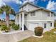 Charming home featuring lush landscaping, white columns, and a welcoming facade at 3344 Gardenia Dr, Hernando Beach, FL 34607