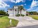 Inviting two-story home featuring a well-maintained lawn, lush landscaping and charming curb appeal at 3344 Gardenia Dr, Hernando Beach, FL 34607