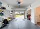 View of an open garage with storage racks on a concrete floor, offering ample space for vehicles at 3344 Gardenia Dr, Hernando Beach, FL 34607