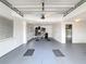 Clean, gray-floored garage featuring white walls, recessed lighting, and ample storage capacity at 3344 Gardenia Dr, Hernando Beach, FL 34607