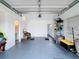 Spacious garage with white walls and gray flooring offering ample space for storage and parking at 3344 Gardenia Dr, Hernando Beach, FL 34607