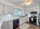 Bright kitchen features white cabinets, stainless steel appliances, and a tile backsplash at 3344 Gardenia Dr, Hernando Beach, FL 34607