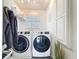 Bright laundry room with a full-size washer and dryer, natural light, storage, and closet at 3344 Gardenia Dr, Hernando Beach, FL 34607