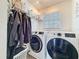 Bright laundry room features a front load washer and dryer and rack for hanging clothes at 3344 Gardenia Dr, Hernando Beach, FL 34607