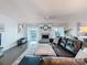 Bright living room boasts a cozy fireplace, ceiling fan and a large leather sectional sofa at 3344 Gardenia Dr, Hernando Beach, FL 34607