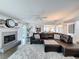 Inviting living room featuring a cozy fireplace, open to the kitchen and outside views at 3344 Gardenia Dr, Hernando Beach, FL 34607