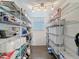 Walk in pantry with metal shelving, filled with various household and food storage items at 3344 Gardenia Dr, Hernando Beach, FL 34607