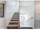 Bright and airy carpeted staircase leading to the upper level with a view of the front door at 3344 Gardenia Dr, Hernando Beach, FL 34607