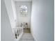 Bright staircase with a decorative table and window at the top landing at 3344 Gardenia Dr, Hernando Beach, FL 34607