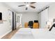 Bright bedroom featuring a ceiling fan, an adjacent office area, and a sliding barn door at 4144 Glade Rd, Spring Hill, FL 34606