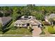 Aerial view of home with well-manicured landscaping, a long driveway, and a tile roof at 5383 Firethorn Pt, Spring Hill, FL 34609