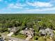 Aerial view of neighborhood featuring large homes with mature trees and landscaping at 5383 Firethorn Pt, Spring Hill, FL 34609