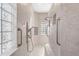 An accessible bathroom featuring tiled walls, grab bars, and a glass block window for natural light at 5383 Firethorn Pt, Spring Hill, FL 34609
