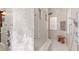 Spacious bathroom with walk in shower featuring glass block window and handrails at 5383 Firethorn Pt, Spring Hill, FL 34609