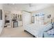 Light bedroom featuring a mini-bar, walk-in closet, a comfortable bed and a window with plantation shutters at 5383 Firethorn Pt, Spring Hill, FL 34609