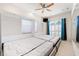 Bright bedroom showcasing a modern Murphy bed, ceiling fan, and a window with light filtering through shutters at 5383 Firethorn Pt, Spring Hill, FL 34609