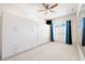 Light-filled bedroom with built in closets, neutral carpet, and a window at 5383 Firethorn Pt, Spring Hill, FL 34609