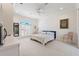 Bright bedroom with tray ceilings, large windows with plantation shutters, and comfortable furniture at 5383 Firethorn Pt, Spring Hill, FL 34609
