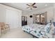 Bright bedroom featuring a ceiling fan, large closet, and sliding glass doors to an outdoor living space at 5383 Firethorn Pt, Spring Hill, FL 34609