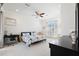 Bright bedroom featuring a ceiling fan, an office area, and a large window letting in natural light at 5383 Firethorn Pt, Spring Hill, FL 34609