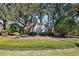 Community entrance featuring brick signage surrounded by lush greenery, creating a welcoming and upscale atmosphere at 5383 Firethorn Pt, Spring Hill, FL 34609