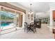 A gorgeous dining room with a fireplace and view of the pool outside at 5383 Firethorn Pt, Spring Hill, FL 34609
