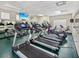 An exercise room with treadmills, elliptical machines, and fitness equipment with mirrors on the wall at 5383 Firethorn Pt, Spring Hill, FL 34609
