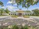 A front exterior view of the community clubhouse, showing the entrance and landscaping at 5383 Firethorn Pt, Spring Hill, FL 34609